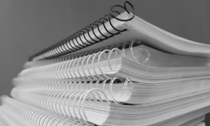 a stack of ringbound journals